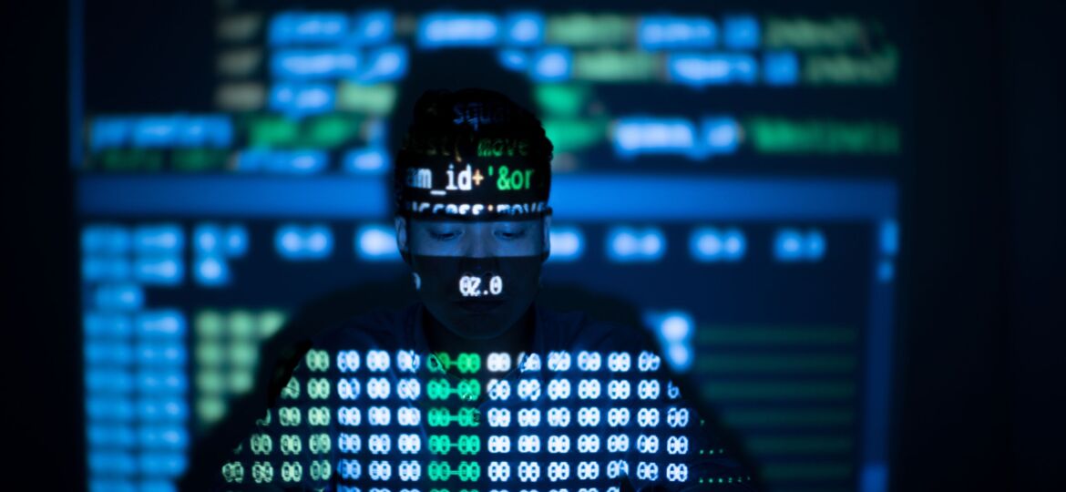 Anonymous hacker in glowing computer interface